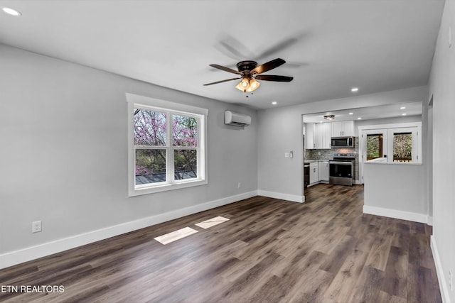 unfurnished living room featuring recessed lighting, a ceiling fan, a wall unit AC, and a healthy amount of sunlight