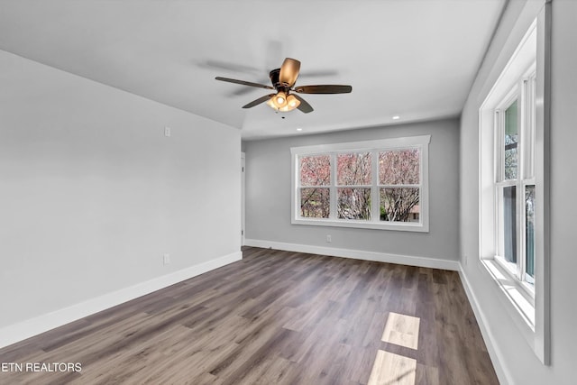 empty room featuring baseboards, a ceiling fan, dark wood-style floors, and recessed lighting