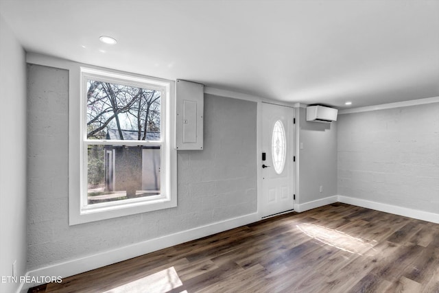 foyer entrance featuring baseboards, electric panel, an AC wall unit, and dark wood-style floors