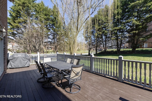 wooden terrace with a fenced backyard, a yard, area for grilling, and outdoor dining space