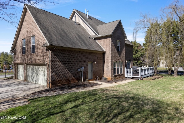 back of property featuring roof with shingles, concrete driveway, a garage, and brick siding
