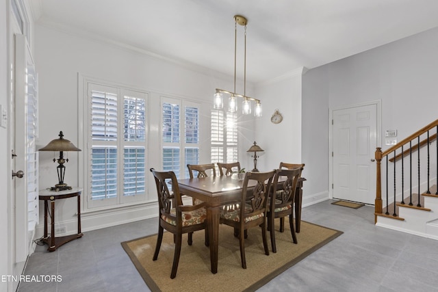dining space with crown molding, baseboards, stairs, and a chandelier