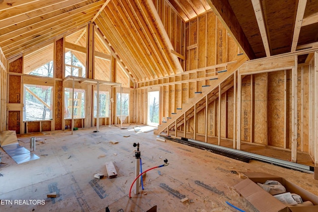 unfurnished living room with a high ceiling