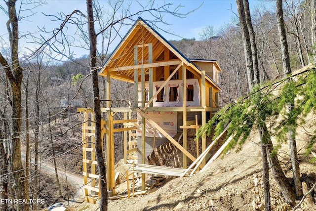 view of outdoor structure featuring a wooded view