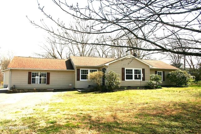ranch-style house featuring crawl space, roof with shingles, and a front lawn