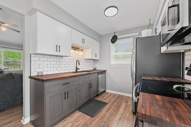 3295 Cimarron Trl, Murfreesboro, TN 37129 - kitchen with butcher block countertops, light wood-style floors, ceiling fan, a sink, and stainless steel appliances