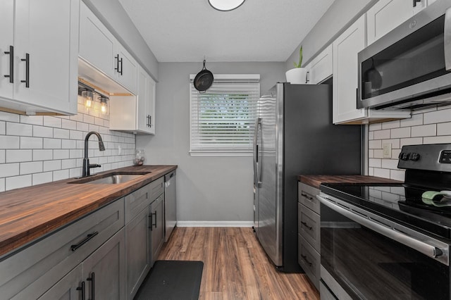 3295 Cimarron Trl, Murfreesboro, TN 37129 - kitchen featuring a sink, tasteful backsplash, stainless steel appliances, and butcher block counters