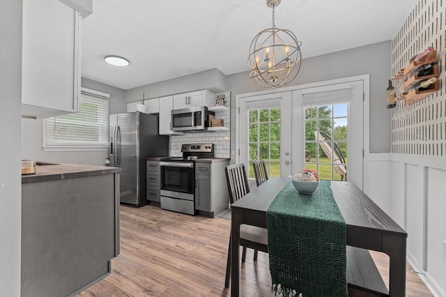 3295 Cimarron Trl, Murfreesboro, TN 37129 - kitchen featuring french doors, light wood-style flooring, a wealth of natural light, and stainless steel appliances