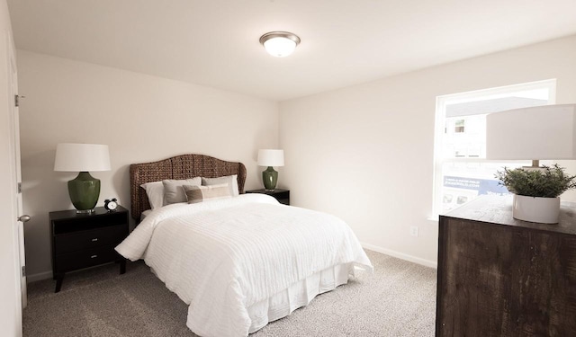 carpeted bedroom featuring baseboards