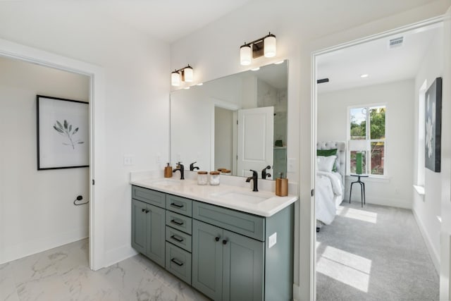 full bathroom with connected bathroom, a sink, double vanity, baseboards, and visible vents