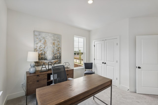 carpeted office space featuring baseboards