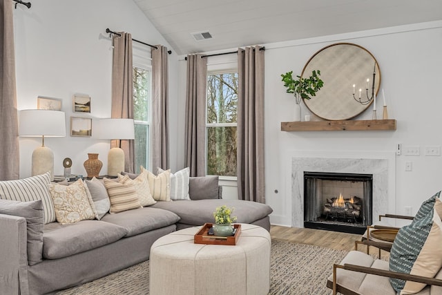 114 Portico Pl, La Vergne, TN 37086 - living room with visible vents, wood finished floors, vaulted ceiling, and a fireplace