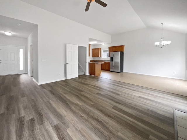 4013 Kristen St, Spring Hill, TN 37174 - unfurnished living room with dark wood-style flooring, ceiling fan with notable chandelier, stairs, baseboards, and vaulted ceiling