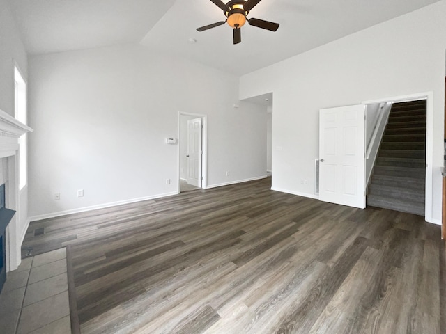 4013 Kristen St, Spring Hill, TN 37174 - unfurnished living room featuring ceiling fan, high vaulted ceiling, stairs, a fireplace with flush hearth, and dark wood-type flooring