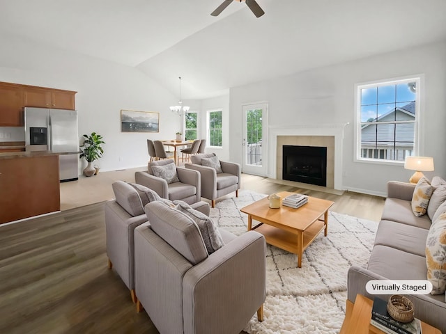4013 Kristen St, Spring Hill, TN 37174 - living room featuring light wood-style flooring, ceiling fan with notable chandelier, lofted ceiling, and a fireplace