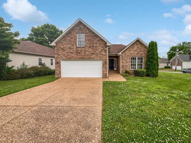 4013 Kristen St, Spring Hill, TN 37174 - view of front of house with brick siding, a front lawn, an attached garage, and driveway