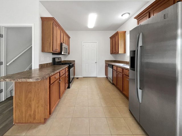 4013 Kristen St, Spring Hill, TN 37174 - kitchen featuring brown cabinets, stainless steel appliances, and dark countertops