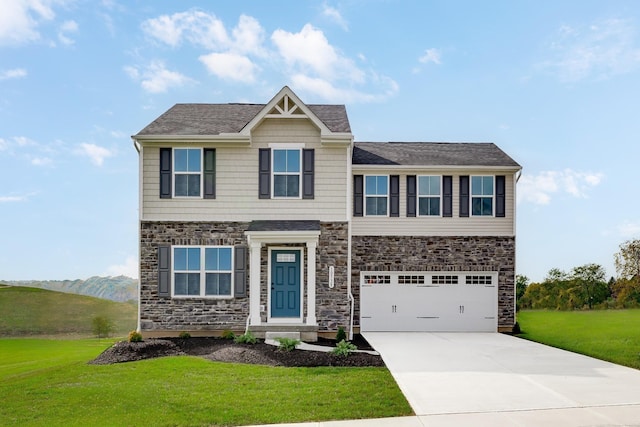craftsman-style home with a garage, concrete driveway, a front yard, and stone siding