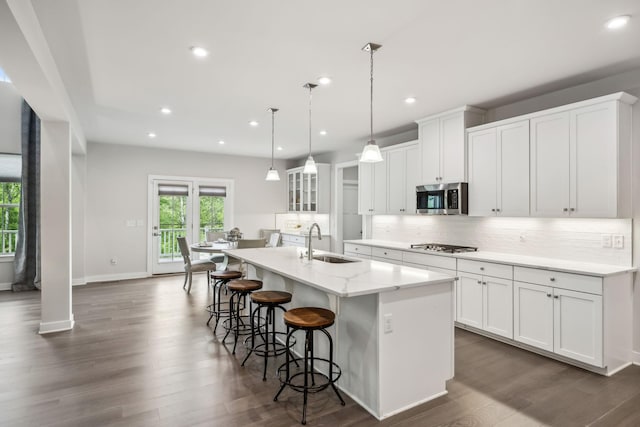 5017 Great Falls Ct, College Grove, TN 37046 - kitchen featuring stainless steel microwave, a sink, a kitchen island with sink, decorative backsplash, and recessed lighting