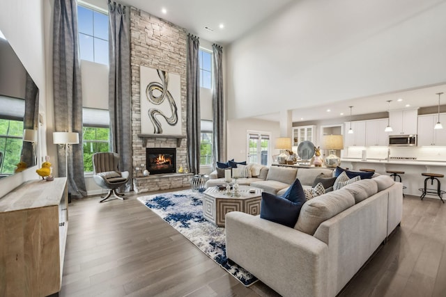 5017 Great Falls Ct, College Grove, TN 37046 - living room with a high ceiling, wood finished floors, a stone fireplace, and recessed lighting