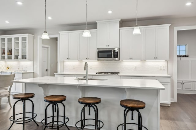 5017 Great Falls Ct, College Grove, TN 37046 - kitchen featuring stainless steel microwave, a sink, decorative backsplash, white cabinetry, and recessed lighting