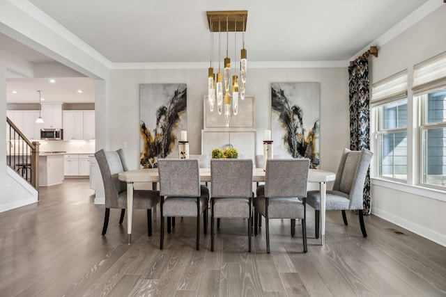 5017 Great Falls Ct, College Grove, TN 37046 - dining space with wood finished floors, a chandelier, crown molding, recessed lighting, and stairway
