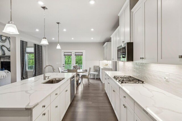 5017 Great Falls Ct, College Grove, TN 37046 - kitchen featuring a sink, stainless steel appliances, backsplash, white cabinets, and an island with sink