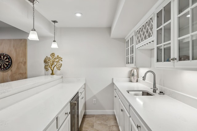 5017 Great Falls Ct, College Grove, TN 37046 - kitchen with a sink, baseboards, wine cooler, pendant lighting, and light countertops