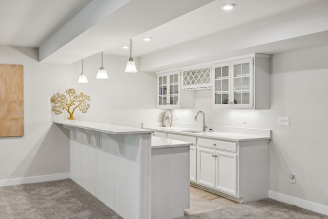 5017 Great Falls Ct, College Grove, TN 37046 - kitchen with a sink, a peninsula, glass insert cabinets, light colored carpet, and recessed lighting