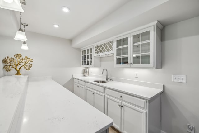 5017 Great Falls Ct, College Grove, TN 37046 - kitchen featuring a sink, glass insert cabinets, recessed lighting, pendant lighting, and white cabinetry