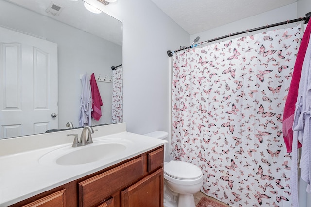 full bathroom with vanity, a shower with shower curtain, visible vents, and toilet