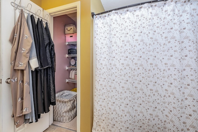 bathroom featuring tile patterned flooring and a shower with shower curtain
