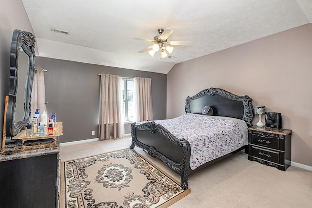 bedroom featuring visible vents, lofted ceiling, baseboards, ceiling fan, and carpet