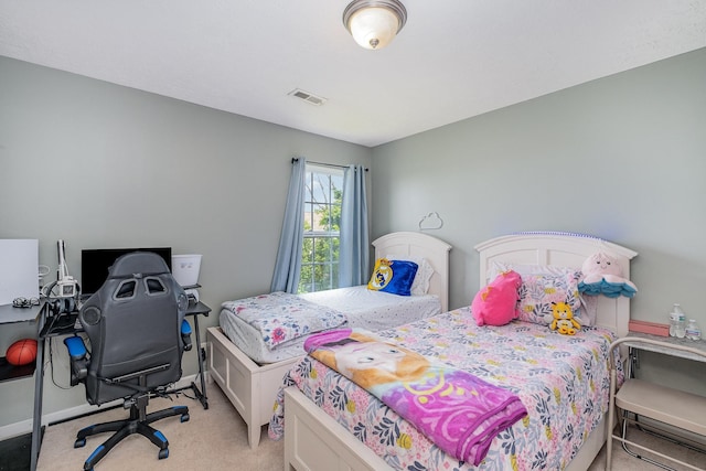 bedroom featuring visible vents, baseboards, and light colored carpet