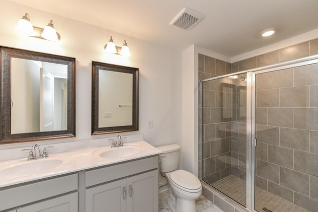 bathroom with visible vents, a sink, a stall shower, and toilet