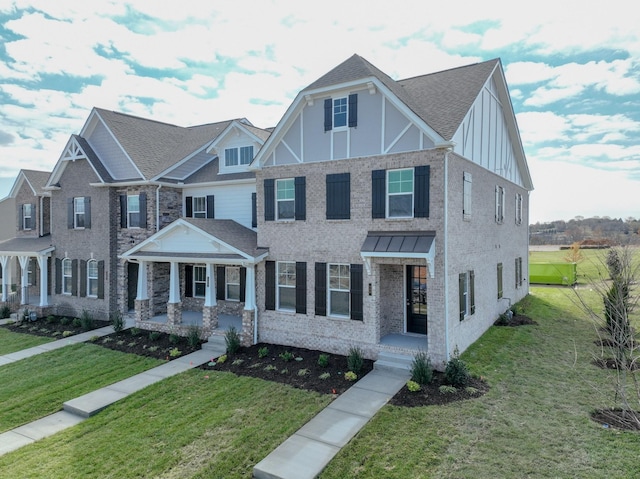 multi unit property with covered porch, board and batten siding, and a front yard