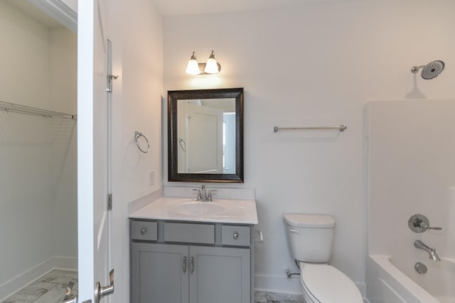 full bathroom with vanity, toilet, marble finish floor, baseboards, and shower / bath combination