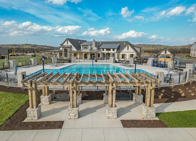 pool with fence, a pergola, and a patio area
