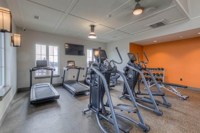 exercise room with baseboards and visible vents