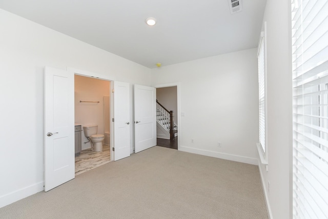 unfurnished bedroom with visible vents, recessed lighting, baseboards, and light colored carpet