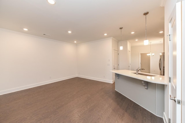 interior space featuring crown molding, recessed lighting, dark wood-style floors, and a sink