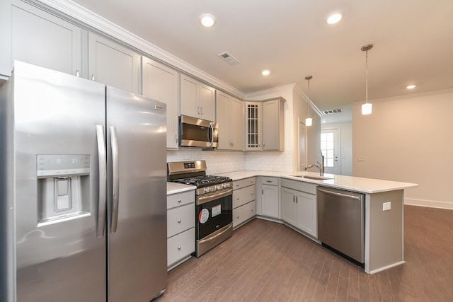 kitchen featuring gray cabinets, visible vents, appliances with stainless steel finishes, a sink, and a peninsula