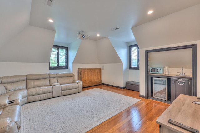 107 Churchill Farms Dr, Murfreesboro, TN 37127 - living room featuring visible vents, wine cooler, lofted ceiling, wood finished floors, and wet bar
