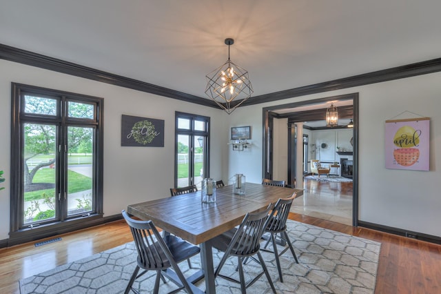 107 Churchill Farms Dr, Murfreesboro, TN 37127 - dining room featuring crown molding, wood finished floors, a chandelier, and visible vents