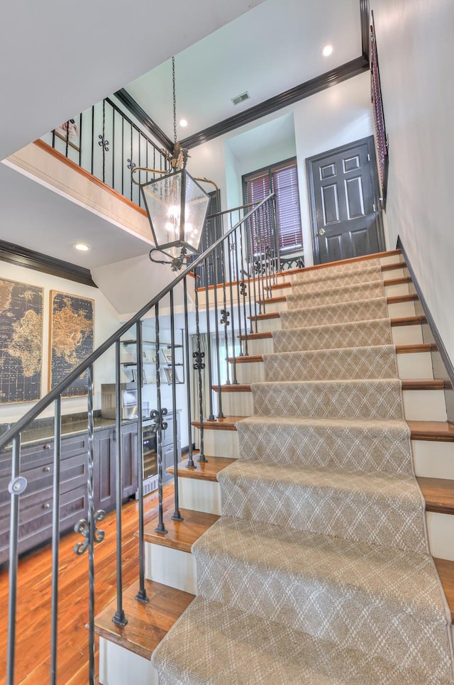 107 Churchill Farms Dr, Murfreesboro, TN 37127 - stairway with a notable chandelier, recessed lighting, wood finished floors, visible vents, and ornamental molding