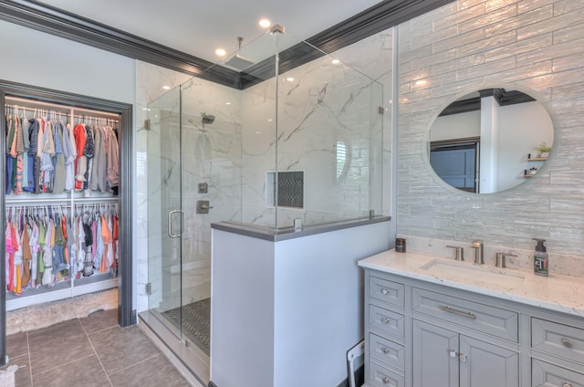 107 Churchill Farms Dr, Murfreesboro, TN 37127 - bathroom featuring vanity, a walk in closet, tile patterned floors, a shower stall, and backsplash