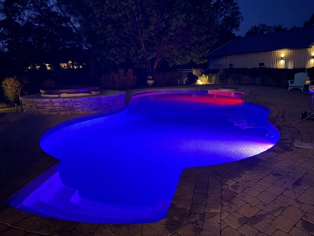 107 Churchill Farms Dr, Murfreesboro, TN 37127 - pool at night with a fenced in pool, an in ground hot tub, a patio area, and a fenced backyard