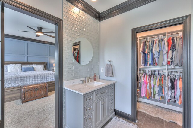 107 Churchill Farms Dr, Murfreesboro, TN 37127 - bathroom featuring crown molding, ceiling fan, a walk in closet, tile patterned flooring, and vanity