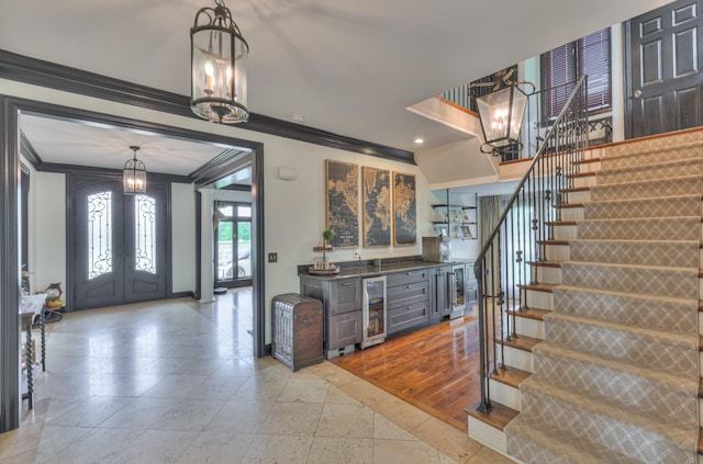 107 Churchill Farms Dr, Murfreesboro, TN 37127 - foyer with crown molding, baseboards, beverage cooler, stairway, and a notable chandelier