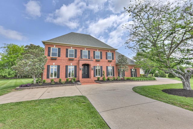 107 Churchill Farms Dr, Murfreesboro, TN 37127 - georgian-style home with brick siding, curved driveway, a shingled roof, and a front lawn